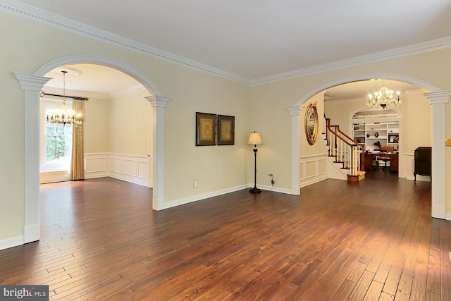 7808 Devereux Manor Ct, Fairfax Station, VA 22039 - unfurnished room with a chandelier, arched walkways, dark wood-style floors, crown molding, and a decorative wall