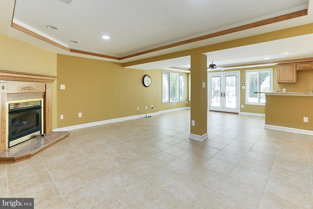 7808 Devereux Manor Ct, Fairfax Station, VA 22039 - unfurnished living room with a tray ceiling, light tile patterned floors, a high end fireplace, recessed lighting, and baseboards