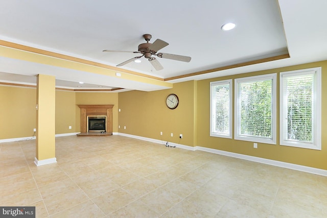 7808 Devereux Manor Ct, Fairfax Station, VA 22039 - unfurnished living room featuring a raised ceiling, a glass covered fireplace, ceiling fan, baseboards, and recessed lighting