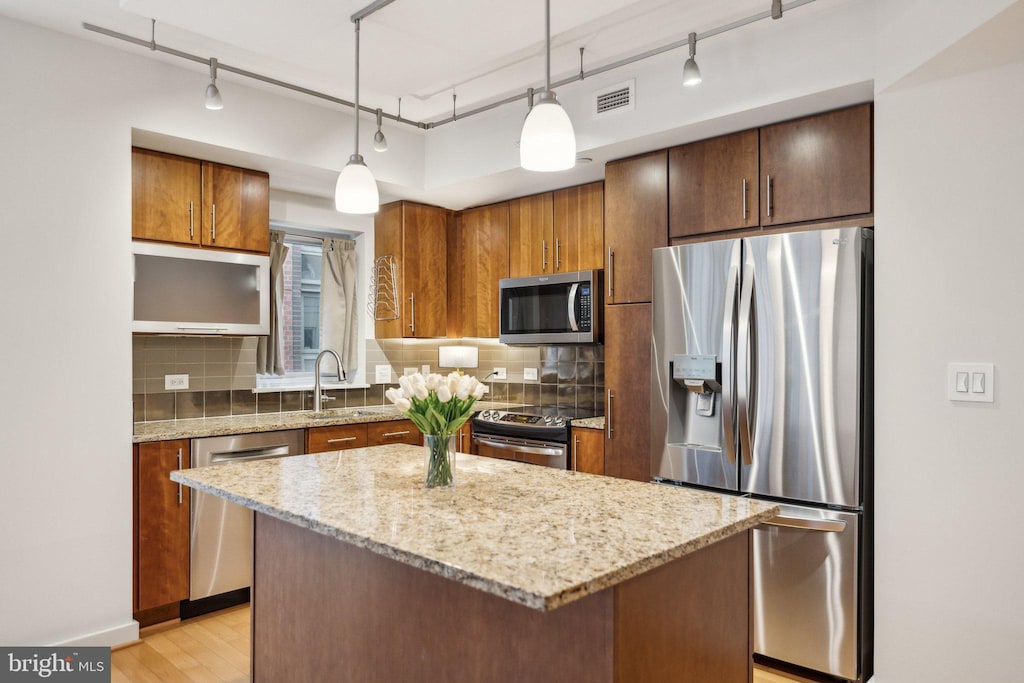 1025 1st St SE Unit 716, Washington, DC 20003 - kitchen with stainless steel appliances, track lighting, tasteful backsplash, and a sink
