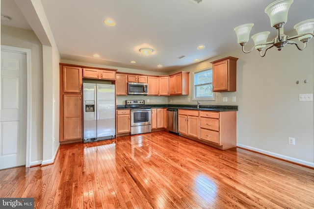 806 Frailey Rd, Emmitsburg, MD 21727 - kitchen featuring appliances with stainless steel finishes, dark countertops, light wood-style floors, baseboards, and a chandelier