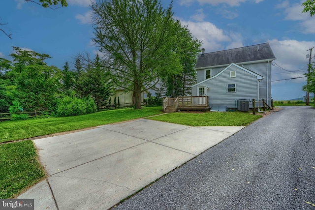 806 Frailey Rd, Emmitsburg, MD 21727 - view of home's exterior with a deck, central AC unit, a lawn, and a shingled roof