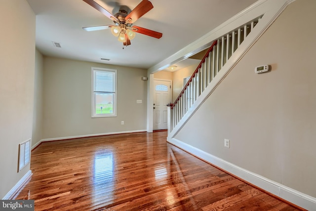 806 Frailey Rd, Emmitsburg, MD 21727 - unfurnished living room featuring a ceiling fan, wood finished floors, baseboards, and stairs