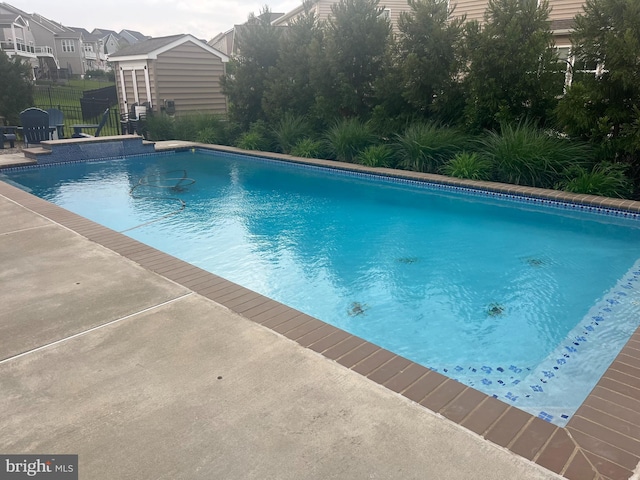 outdoor pool featuring fence