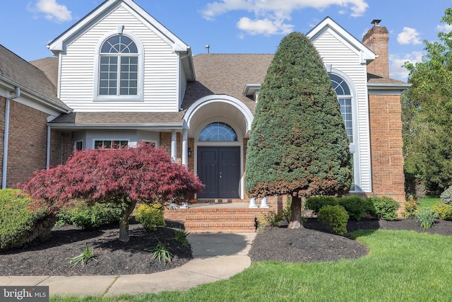 4 Stults Dr, Plainsboro, NJ 08536 - view of front of home with roof with shingles, a chimney, and brick siding