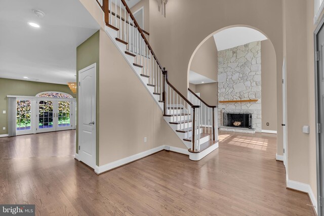 4 Stults Dr, Plainsboro, NJ 08536 - stairway with a fireplace, wood finished floors, baseboards, and a towering ceiling