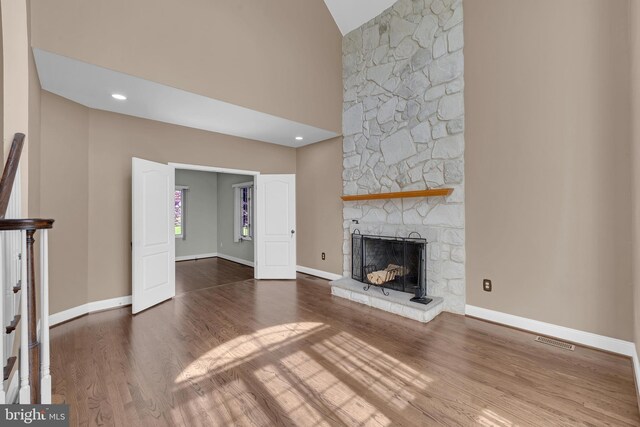 4 Stults Dr, Plainsboro, NJ 08536 - unfurnished living room with wood finished floors, a stone fireplace, baseboards, and high vaulted ceiling