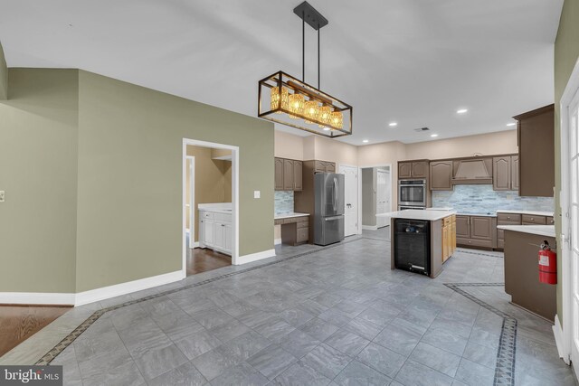 4 Stults Dr, Plainsboro, NJ 08536 - kitchen featuring stainless steel appliances, a center island, tasteful backsplash, light countertops, and baseboards