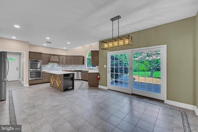 4 Stults Dr, Plainsboro, NJ 08536 - kitchen featuring light countertops, stainless steel appliances, a center island, baseboards, and beverage cooler
