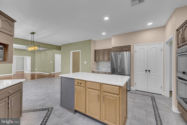 4 Stults Dr, Plainsboro, NJ 08536 - kitchen featuring stainless steel appliances, inlaid floor details, a kitchen island, light countertops, and baseboards