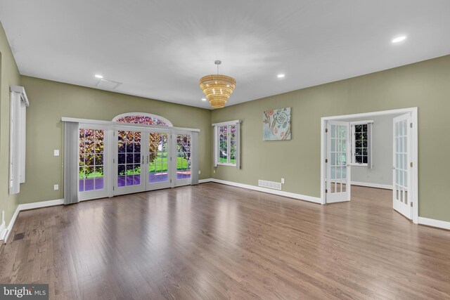 4 Stults Dr, Plainsboro, NJ 08536 - unfurnished living room featuring french doors, wood finished floors, baseboards, recessed lighting, and a chandelier