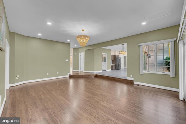 4 Stults Dr, Plainsboro, NJ 08536 - unfurnished living room with wood finished floors, baseboards, recessed lighting, and a chandelier