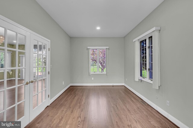 4 Stults Dr, Plainsboro, NJ 08536 - empty room featuring french doors, wood finished floors, and baseboards