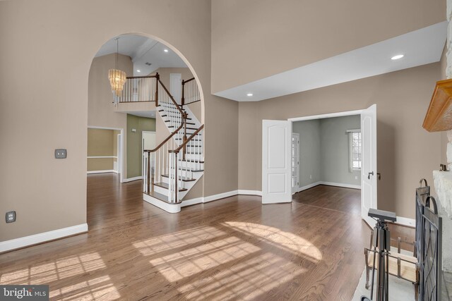 4 Stults Dr, Plainsboro, NJ 08536 - unfurnished living room featuring wood finished floors, baseboards, a high ceiling, and recessed lighting