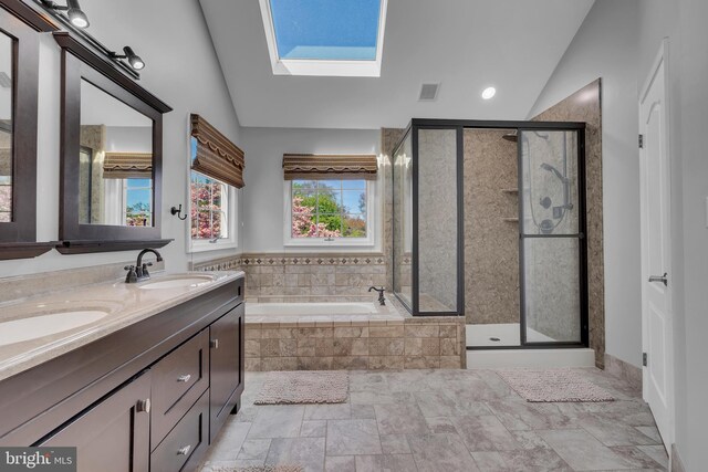4 Stults Dr, Plainsboro, NJ 08536 - bathroom with vaulted ceiling, a skylight, a garden tub, a shower stall, and double vanity