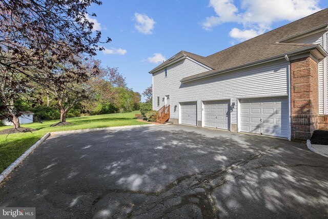 4 Stults Dr, Plainsboro, NJ 08536 - view of side of home featuring driveway, a lawn, a shingled roof, and brick siding