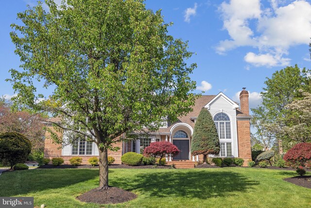 4 Stults Dr, Plainsboro, NJ 08536 - obstructed view of property featuring brick siding, a front yard, and a chimney