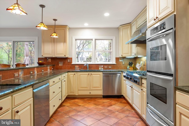 902 Emerald Dr, Alexandria, VA 22308 - kitchen featuring appliances with stainless steel finishes, cream cabinetry, a warming drawer, plenty of natural light, and recessed lighting