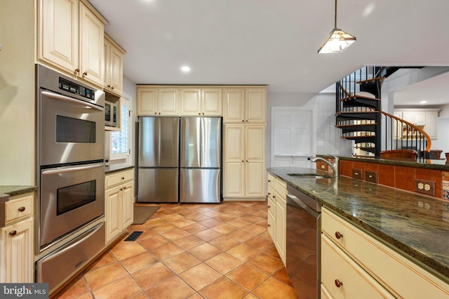 902 Emerald Dr, Alexandria, VA 22308 - kitchen with a sink, appliances with stainless steel finishes, cream cabinets, a warming drawer, and recessed lighting