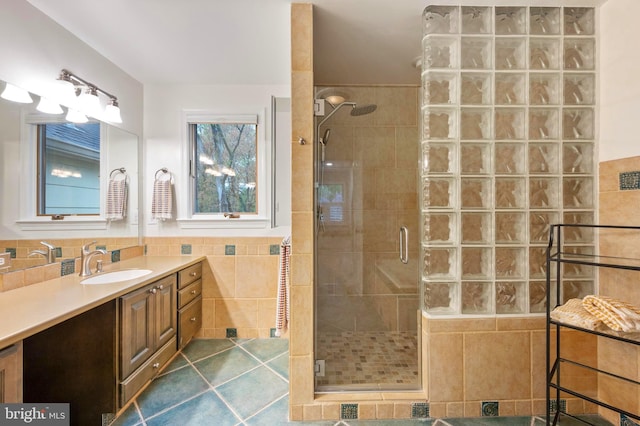 902 Emerald Dr, Alexandria, VA 22308 - bathroom featuring a stall shower, tile walls, vanity, and tile patterned flooring