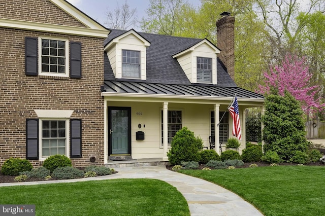 902 Emerald Dr, Alexandria, VA 22308 - view of front of property featuring a standing seam roof, a shingled roof, a chimney, a front yard, and brick siding