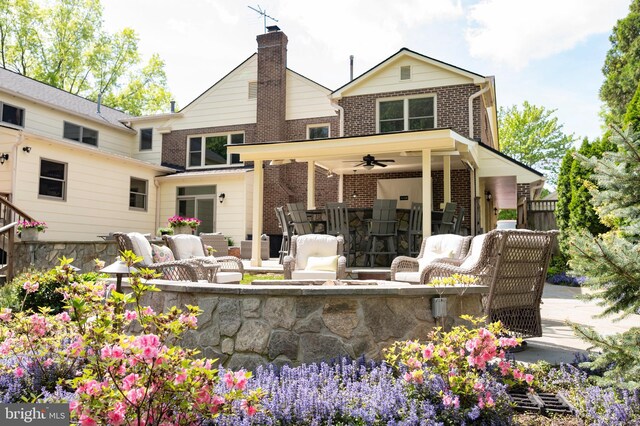 902 Emerald Dr, Alexandria, VA 22308 - rear view of house featuring ceiling fan, brick siding, a patio, and an outdoor living space with a fire pit