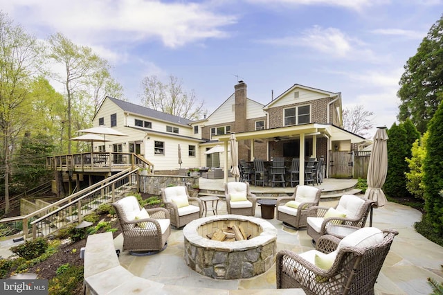 902 Emerald Dr, Alexandria, VA 22308 - back of house with a deck, brick siding, an outdoor living space with a fire pit, stairway, and a patio area