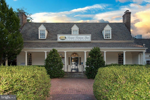 902 Emerald Dr, Alexandria, VA 22308 - cape cod-style house featuring covered porch, a shingled roof, and a chimney