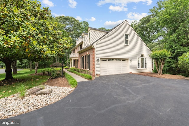502 Pride Of Baltimore Dr, Arnold, MD 21012 - view of home's exterior with asphalt driveway, brick siding, and a garage