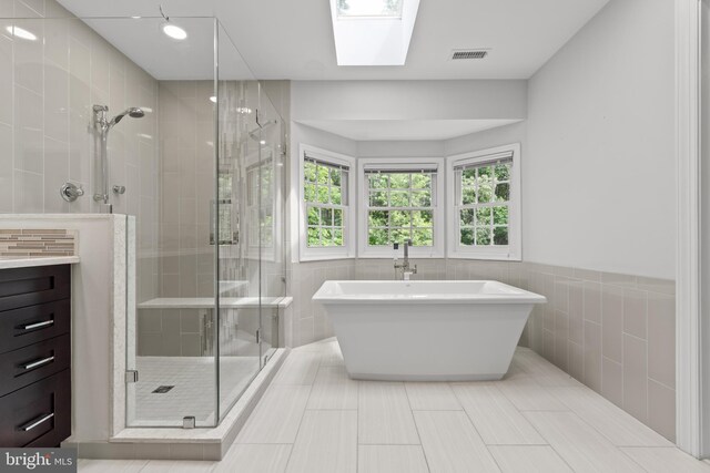 502 Pride Of Baltimore Dr, Arnold, MD 21012 - bathroom with tile walls, a shower stall, a soaking tub, wainscoting, and vanity