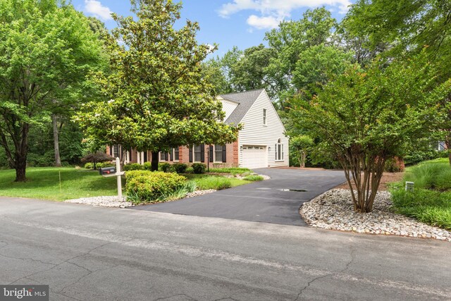 502 Pride Of Baltimore Dr, Arnold, MD 21012 - view of property hidden behind natural elements with driveway, an attached garage, and a front lawn