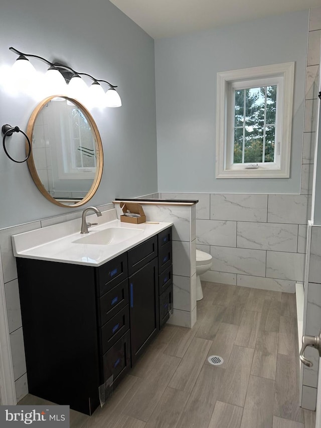 64B Kirk Rd, Garnet Valley, PA 19061 - bathroom with tile walls, vanity, wood finished floors, wainscoting, and toilet