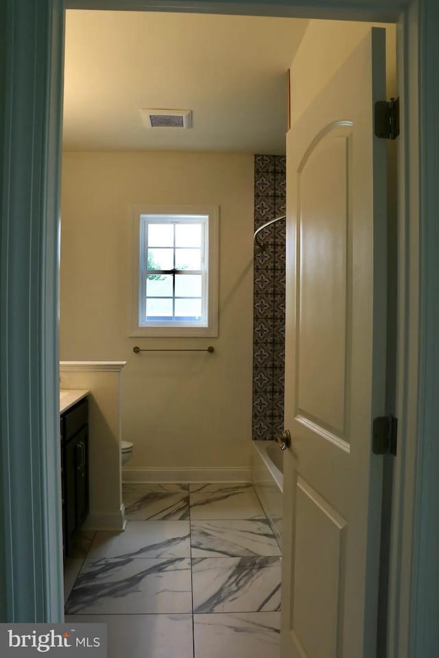 64B Kirk Rd, Garnet Valley, PA 19061 - bathroom with vanity, marble look tiles, toilet, baseboards, and  shower combination
