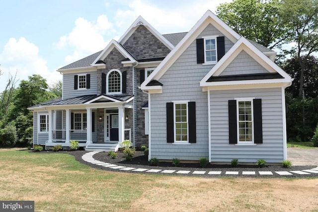 64B Kirk Rd, Garnet Valley, PA 19061 - craftsman-style home with a porch, a front lawn, stone siding, and a standing seam roof