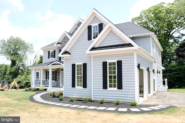 64B Kirk Rd, Garnet Valley, PA 19061 - view of front of home featuring a standing seam roof, covered porch, metal roof, and a front yard