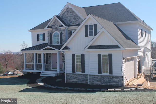 64B Kirk Rd, Garnet Valley, PA 19061 - view of front of home with stone siding, a standing seam roof, a porch, a shingled roof, and metal roof