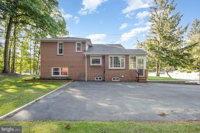 3912 E Joppa Rd, Nottingham, MD 21236 - back of property with brick siding, asphalt driveway, and a lawn