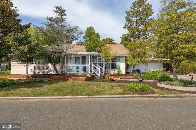 60 Holly, Long Beach Township, NJ 08008 - view of front of home featuring covered porch, a front lawn, and an attached garage