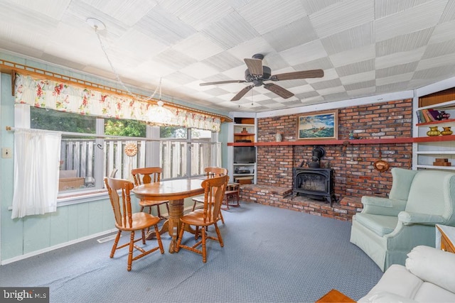 60 Holly, Long Beach Township, NJ 08008 - carpeted dining area with a wood stove, a ceiling fan, and baseboards
