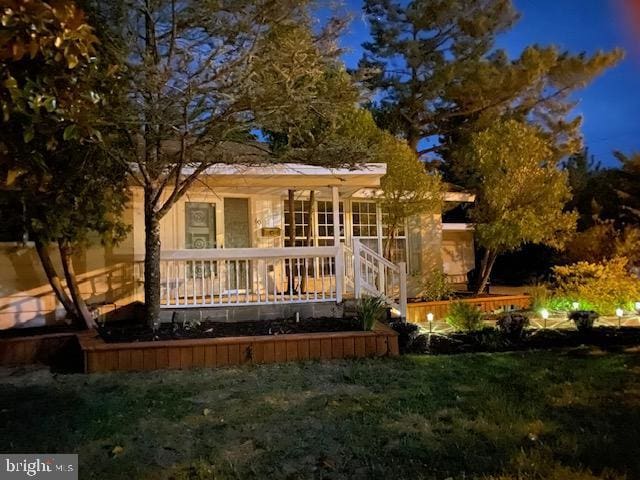 60 Holly, Long Beach Township, NJ 08008 - view of front of house with a front yard and a wooden deck