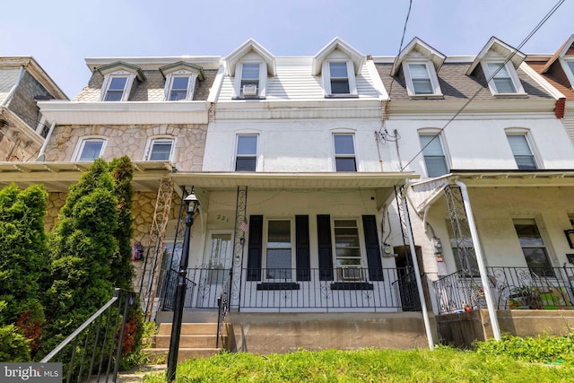 221 Rochelle Ave, Philadelphia, PA 19128 - view of property featuring a porch and mansard roof
