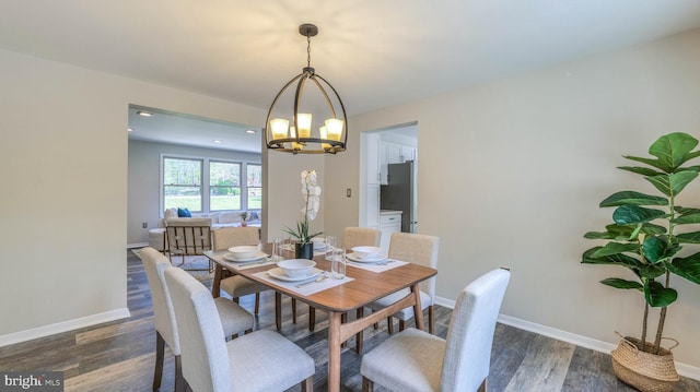 6057 English Creek Ave, Egg Harbor Township, NJ 08234 - dining space featuring a chandelier, baseboards, and dark wood-style flooring