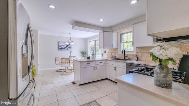6057 English Creek Ave, Egg Harbor Township, NJ 08234 - kitchen featuring stainless steel fridge, a sink, a peninsula, light countertops, and decorative backsplash