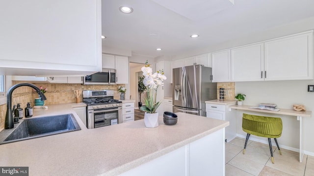 6057 English Creek Ave, Egg Harbor Township, NJ 08234 - kitchen featuring stainless steel appliances, a sink, tasteful backsplash, white cabinetry, and recessed lighting