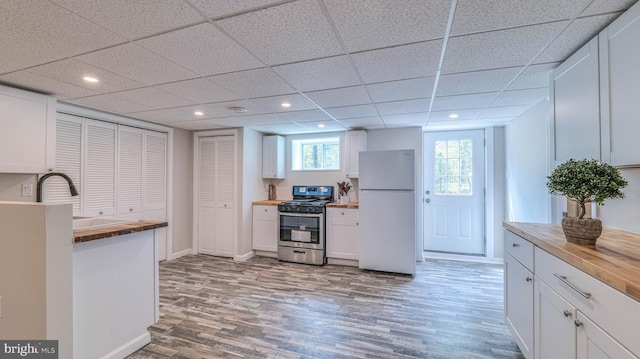 6057 English Creek Ave, Egg Harbor Township, NJ 08234 - kitchen with freestanding refrigerator, stainless steel gas stove, butcher block countertops, a sink, and recessed lighting