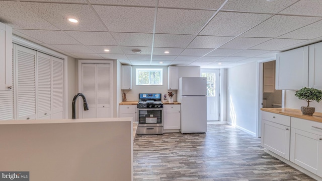 6057 English Creek Ave, Egg Harbor Township, NJ 08234 - kitchen featuring freestanding refrigerator, gas stove, wood finished floors, white cabinetry, and wooden counters
