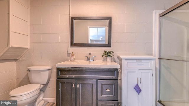 6057 English Creek Ave, Egg Harbor Township, NJ 08234 - bathroom with an enclosed shower, vanity, toilet, and concrete block wall