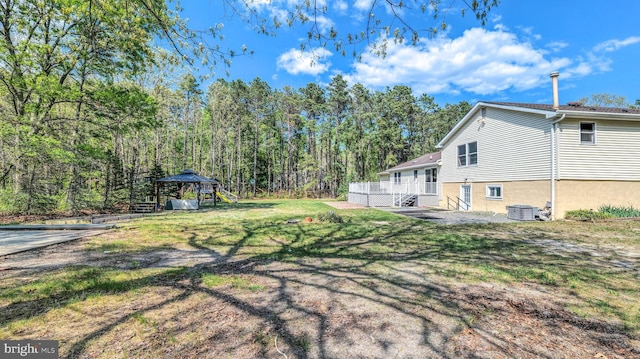 6057 English Creek Ave, Egg Harbor Township, NJ 08234 - view of green lawn featuring a playground, cooling unit, and a deck