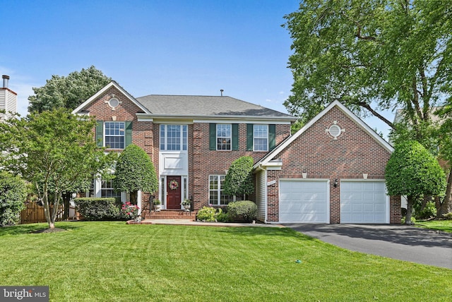 view of front of home with asphalt driveway, brick siding, and an attached garage