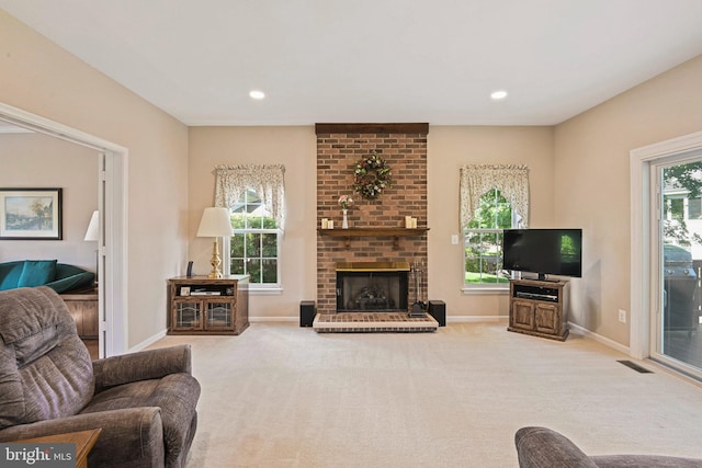 living room featuring carpet floors, a brick fireplace, baseboards, and recessed lighting